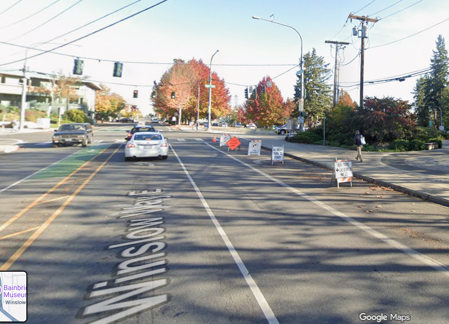 Eastbound view of Winslow Way intersection with highway, with signs impeding the right lane